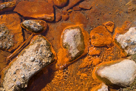 The stones in the mineral water source with the high content of ironの写真素材