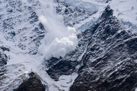 Snow avalanche on mountain slopeの写真素材