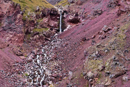 Small waterfall among the pink volcanic rocksの写真素材