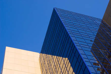 The walls of a modern office building on a background of blue skyの写真素材