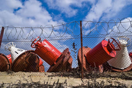 River buoy over a wire fence on a background of blue skyの写真素材