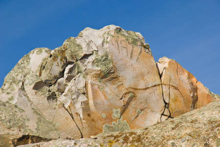 Pinkish-orange rock against the blue skyの写真素材