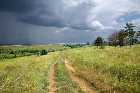 Country road in the steppe before the stormの写真素材