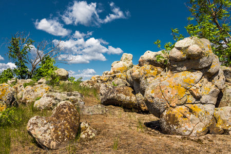 Natural landmark Bolshoy Kamen near the town of Kamensk-Shakhtinsky, Rostov region, Russia. Fancy shaped boulders under a blue sky with white cloudsの写真素材