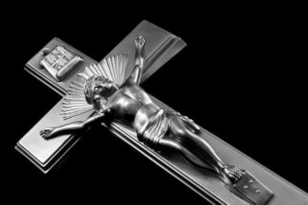 Black and white image of a bronze Crucifixの写真素材