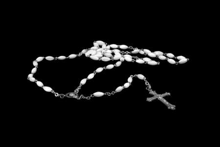 Black and white image of a Rosary made of white marble prayer beads and silver chain links and Crucifixの写真素材