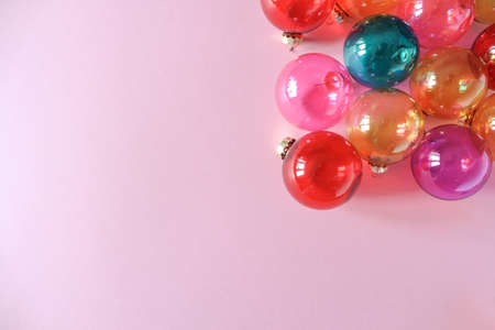 Colourful translucent glass Christmas baubles on pink background. Place for text. Top viewの写真素材