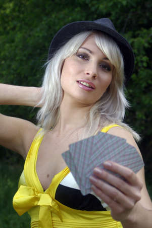 Bleached blonde in a country hat with cardsのeditorial素材