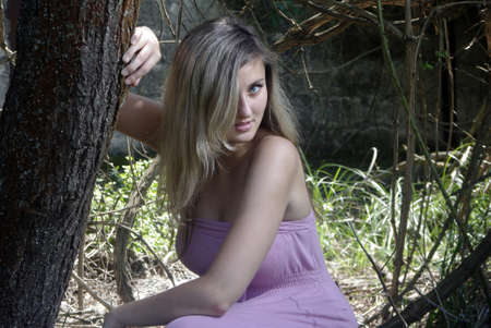 Blonde smiling in a summer forestの写真素材