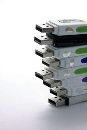 Stack of USB drive connectors on a white with soft shadow