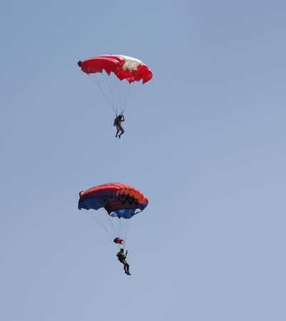 men on paraglider in the skyの写真素材