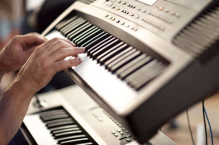 musician hands on keyboards playing