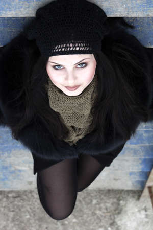 young lady on a wooden blue ladderの写真素材