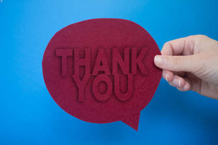Speech bubble in front of colored background with Thank You text.の写真素材