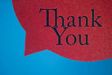 Speech bubble in front of colored background with Thank You text.の写真素材