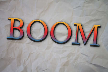 Boom text with Torn, Crumpled White Paper on colored background.の写真素材