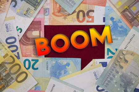 Boom word with money. Paper currency background with different banknotes.