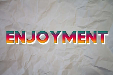Enjoyment text with Torn, Crumpled White Paper on colored background.