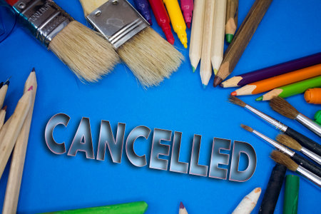 Overhead shot of school supplies with Cancelled text. Brushes, pencils, artistic tools. Art And Craft Work Tools.の写真素材