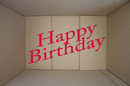 Happy Birthday word with cardboard box. Brown folded card box.の写真素材