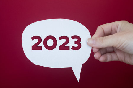 Speech bubble in front of colored background with the number 2023.の写真素材