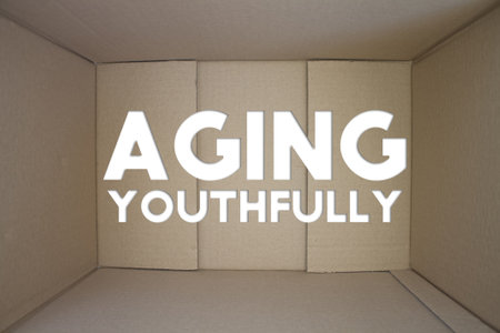 Aging Youthfully word with cardboard box. Brown folded card box.の写真素材