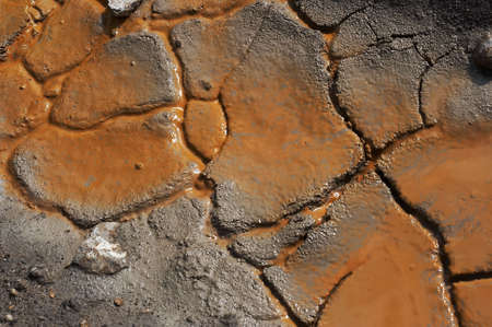 Crannied soil in an earthen pit after rain