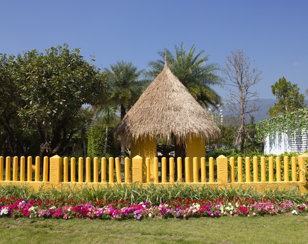 Yellow fence and flower gardenの写真素材
