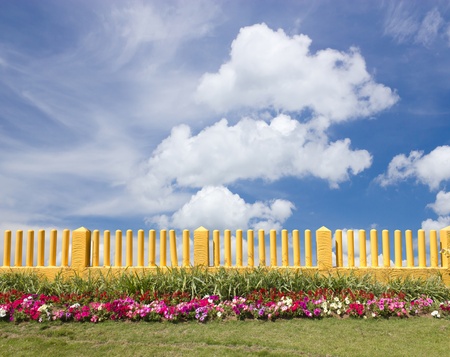 Yellow fence and flower gardenの写真素材