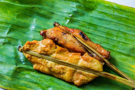 Roasting chicken on a banana leafの写真素材