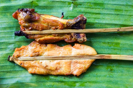 Roasting chicken on a banana leafの写真素材