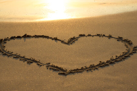 Heart drawing on the beachの写真素材