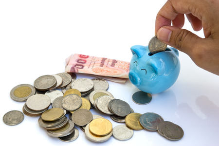 Drops money into the piggy bankの写真素材