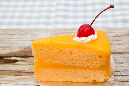 Orange cake on wood backgroundの写真素材