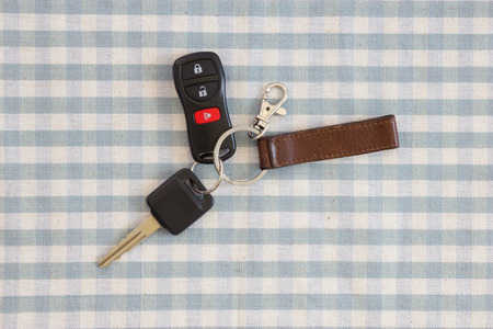 Remote car key on tableclothの写真素材