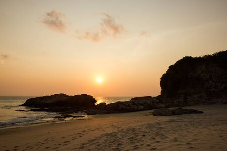 Sunset on the rocks beachの写真素材