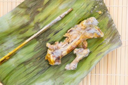 chicken bone with fungus on banana leaf