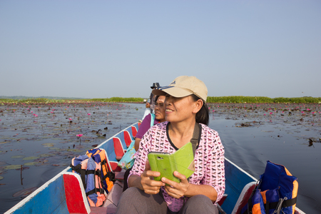 PHATTHALUNG, THAILAND - APRIL 14 : Tourist boat travel for see pink lotus lake and waterfowl on APRIL 14, 2016 in Thale Noi, Phatthalung, Thailandのeditorial素材