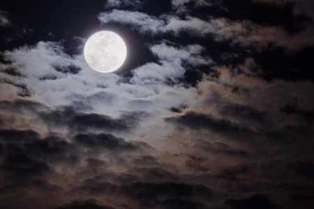 Full moon in the cloudsの写真素材