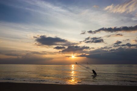 Fishermen are fishing on the beachの写真素材