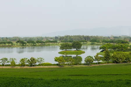 Farmhouse pond and mountain viewsの写真素材
