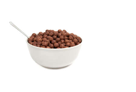 chocolate balls falling into bowl isolated