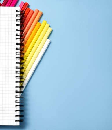 Stack of color pencil and notebook on blue paper background ,Business object. For School. Kids.