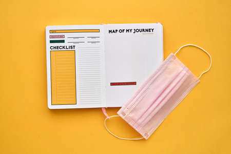 Coronavirus travel concept. Face Mask Medical Protective and Travel book.Covid-19 novel coronavirus...