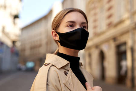 Woman wearing trendy fashion outfit during quarantine of coronavirus outbreak. Model dressed...