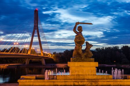 Historic Mermaid near bridge Swietokrzyski over the Vistula river in Warsaw, Polandの写真素材