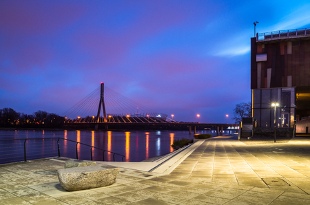 Dawn on the Swietokrzyski bridge over the Vistula river and boulevards in Warsaw, Polandの写真素材