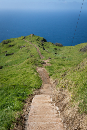Cliff over the Atlantic ocean in Lombada Velha on the Madeira island, Portugalの写真素材