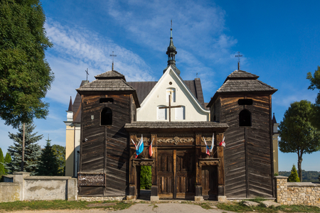 Church and larch gate in Krynki, Swietokrzyskie, Polandの写真素材