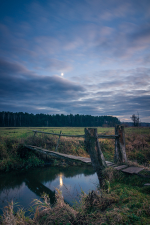 Bridge over the Jeziorka river at cloudy day near Piaseczno, Masovia, Polandの写真素材